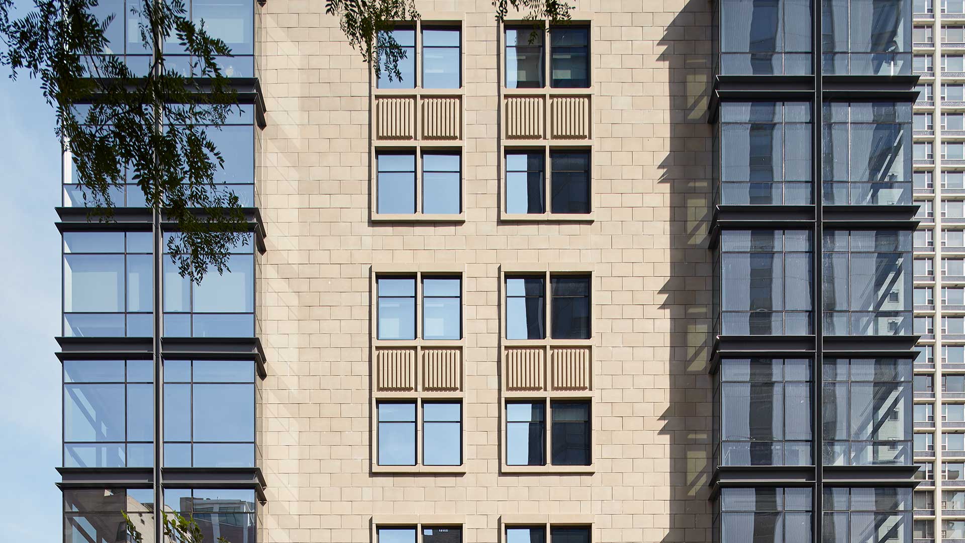 A close-up of the exterior of 61 Banks Street, stone facade and windows.